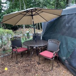 Newly painted outside table and chairs with umbrella