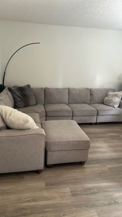 L-shaped light gray sofa with ottoman