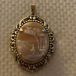 Hand-carved cameo pendants featuring women and landscape, crafted from conch or carnelian   