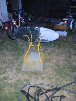 Round Glass-Too Dining Table With A Curved  Yellow-Painted Metal Frame 