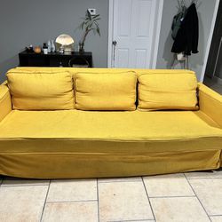 Black Friheten Ikea Couch With Yellow Cover 