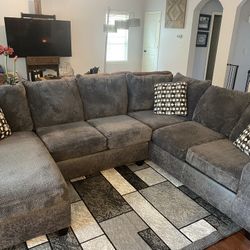 Very  beautiful gray three-piece sectional with Storage ottoman