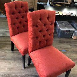 is a pair of Radley Red Tufted Upholstered Dining Chairs
