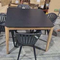 BRAND NEW Hard Wood Dining Table with Polypropylene All weather Top and (4) Black Aluminum & Recycled Resin Chairs
