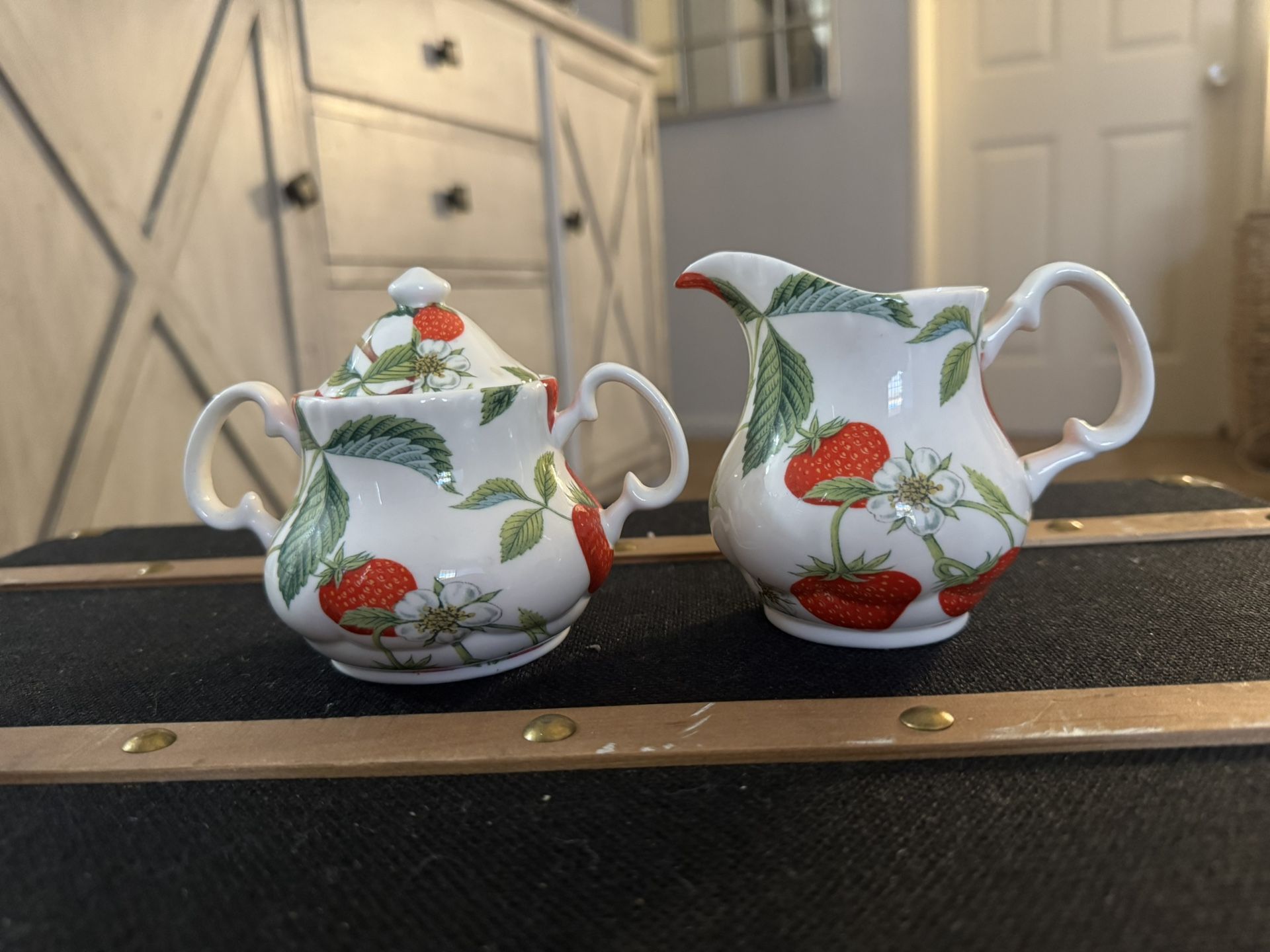 Roy Kirkham Alpine Strawberry sugar bowl with lid and a creamer. Roy Kirkham is known for producing fine bone china in England since 1970. 