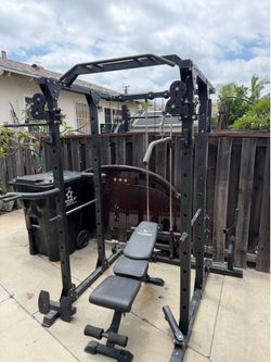 Squat rack cage with pully system.  Plus bench