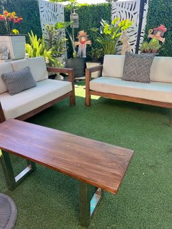 3-piece wooden patio set. It needs cushion covers and has damage on the underside.