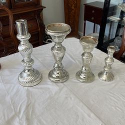 Four glass silver candlesticks