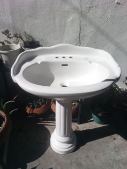 White pedestal sink with base