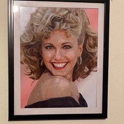 Custom art piece of Olivia Newton John from the film grease in black frame