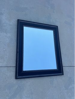 Dark brown framed mirror
