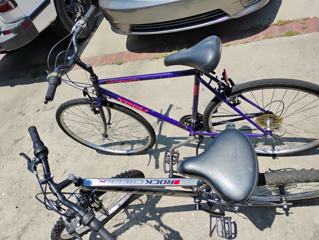 TWO BIKES PURPLE TREK MULTI TRACK 700, AND GRAY HUFFY ROCK CREEK 24