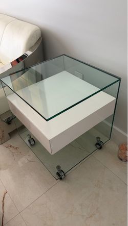 Modern Glass and White Lacquer End Table on Wheels .