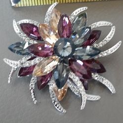 Brooch with multicolor gemstones & silver accents.