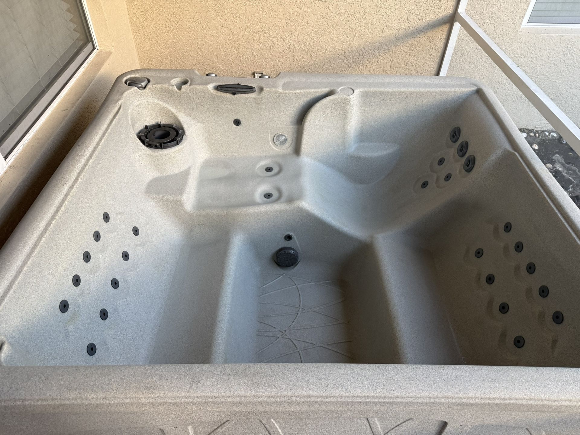 Spacious outdoor hot tub with multiple jets. Outdoor Hot Tub Barely used, less than 2 years old, works perfectly, come see in person! Paid $3300.