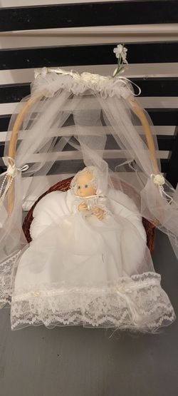 Porcelain baby with bed.