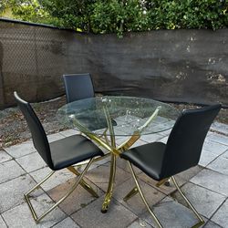 Round gold Glass table with three chairs