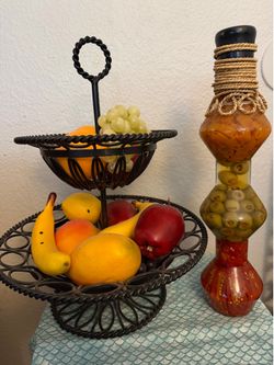 Metal Basket w/artificial fruit. Sealed, decorative bottle containing preserved vegetables