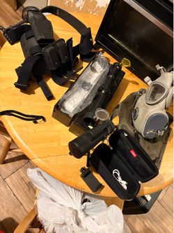 Bunch of cool stuff gun holster leg and waste belt, gas mask, scope and spotter scope! 70$