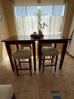 Two wooden pub tables tables square, four barstools with vinyl cover seats