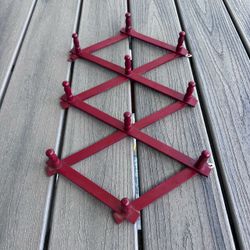 Vintage wood accordion 10 peg hat/coat rack has been painted in cranberry