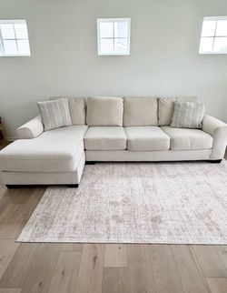 Cream L-shaped Ashley couch. Negotiable