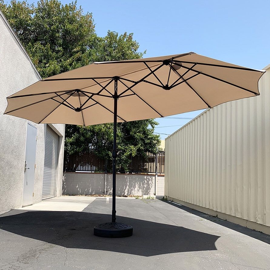 $130 (Brand New) Large 15 ft double sided outdoor umbrella with 65 lbs plastic weight base (beige color)