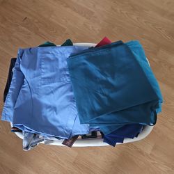 Basket full of nursing scrubs different Sizes Some With Tags. $3 each