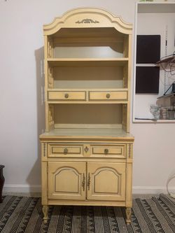 Dixie cream-colored hutch features ornate hardware and classic rococo-style arched details
