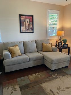 Beige sofa with reversible chaise. Matching oversized chair (not pictured) $250/obo