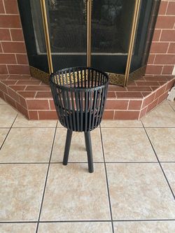 Sagebrook Home footed planter, featuring a black slatted or caged design