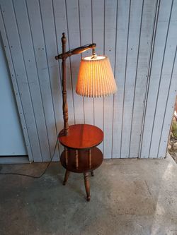 Vintage 1960's floor lamp with table and storage. Works and is in good condition.