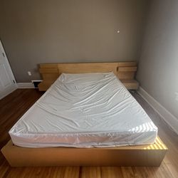 Queen bed with attached nightstands