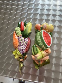 Elegant ceramic wall decoration for the kitchen featuring various figures.