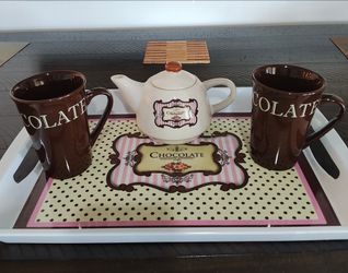 Tray with 2 cups and a small creamer pot.
