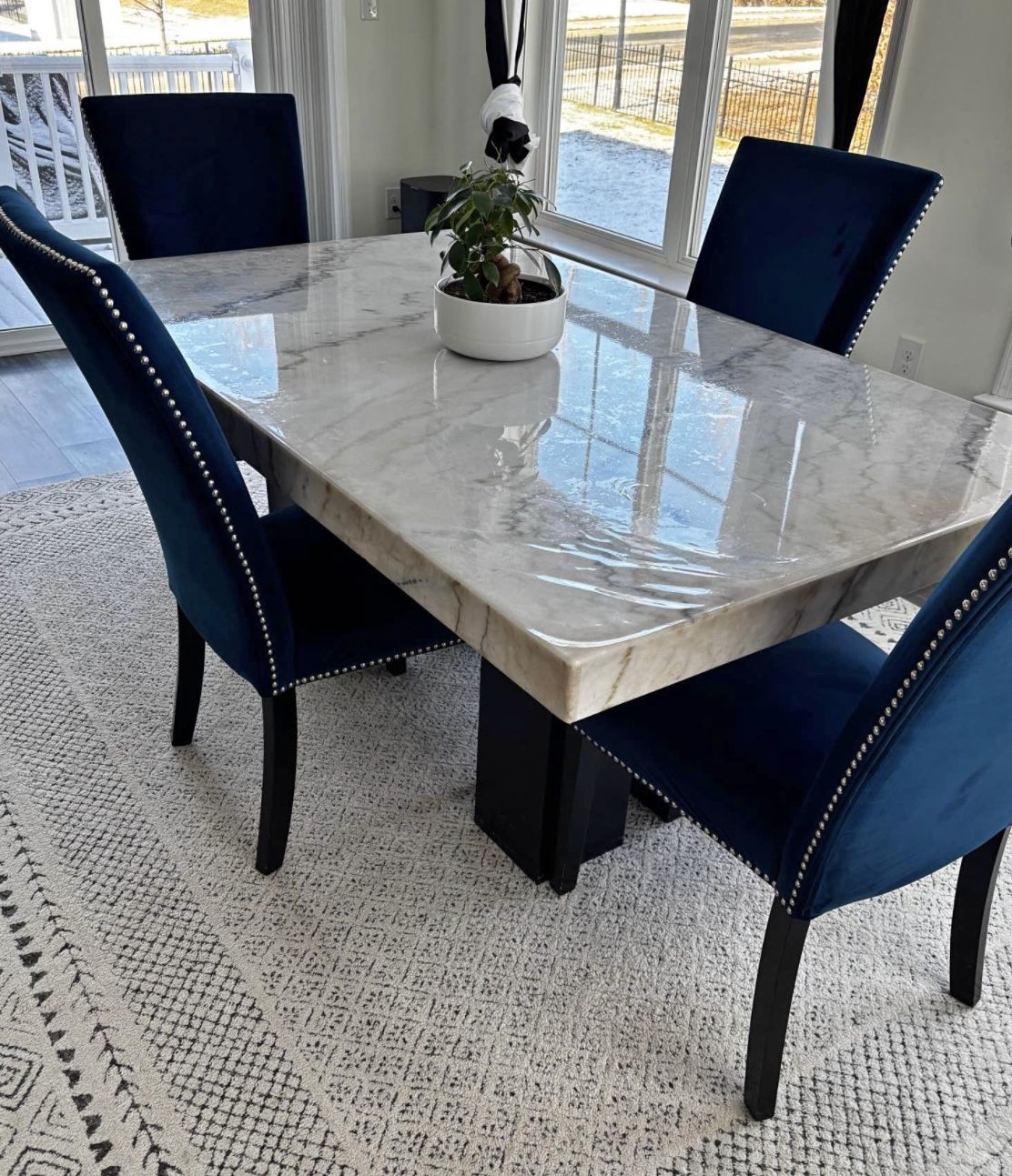 Pure White Marble Dining Table with 4 Royal Blue Chairs and Blue/White Car.