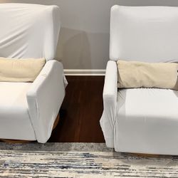 Pair of beige Reclining Chairs with Pillows from Crate and Barrel