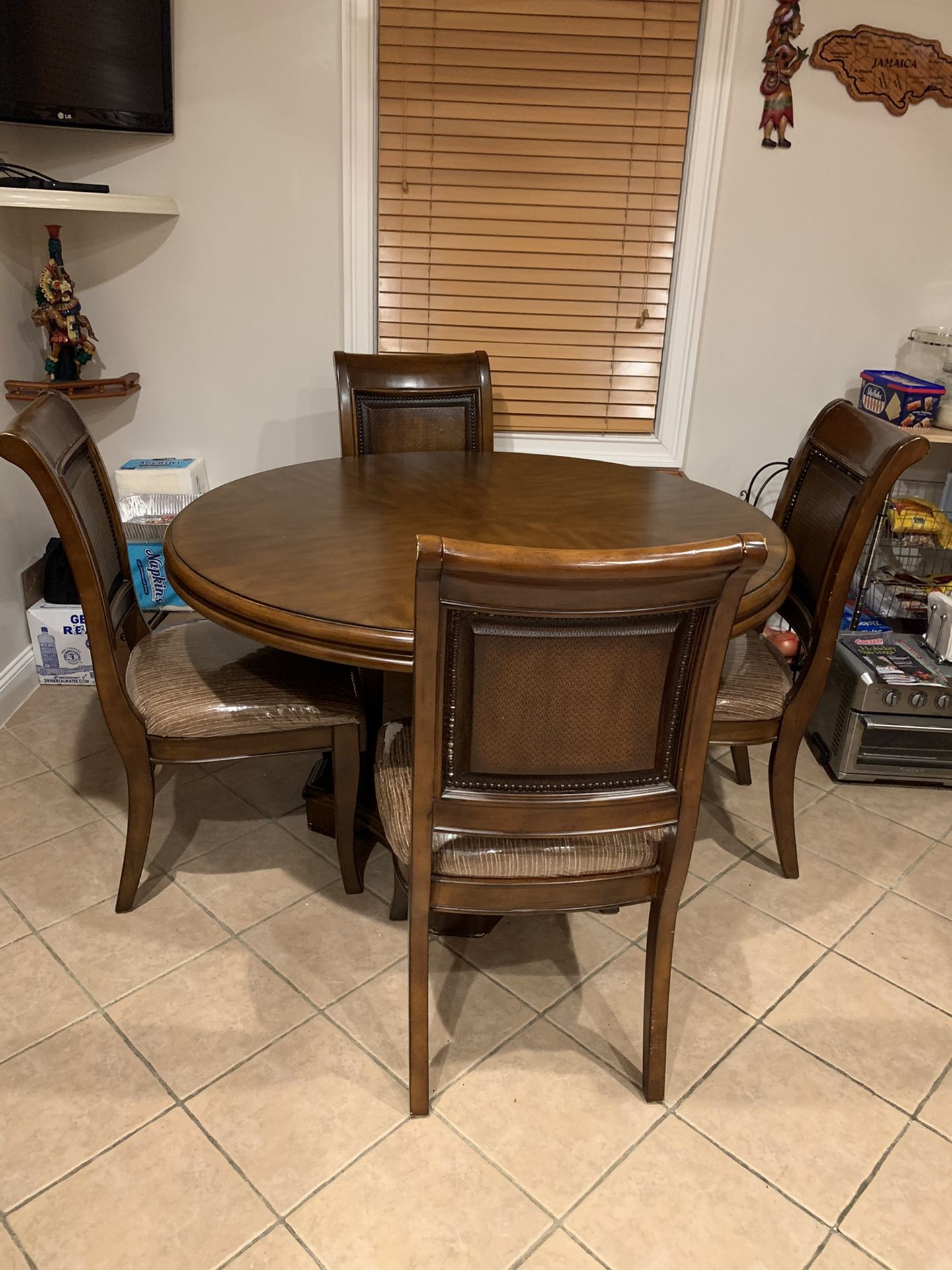 Kitchen table 54” round with 4 covered chairs.