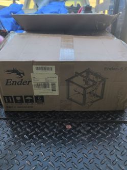 The box displays the brand and model name Creality Ender-5 https://offerup.com/redirect/?o=UHJvLkl0 is an FDM 3D printer featuring a cubic frame desig