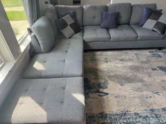 Grey sectional with storage ottoman