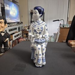 Vintage Mid To Late 20th Century Porcelain With Blue & White Glaze Chinoiserie Style Asian Lady Sitting On A Stool W/Bowl Of Flowers 11.5"H X 6"L X 5"