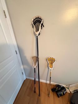 Lacrosse sticks- burnpro max long pole, 2 short sticks one has Nike head.