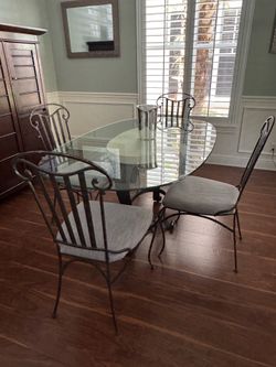 Oval Glass Top Dining Table with Stone Base and 4 Wrought Iron Chairs
