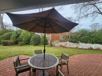 Smith and Hawken Outdoor patio dining set with a table, four chairs, and umbrella.
