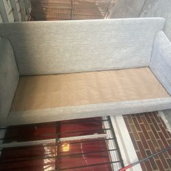 Gray sofa. Three pillows at the bottom