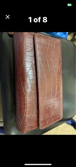 Brown croc pattern wallet snap closure many compartments for cards and other items. 2 zippers 