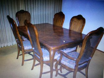 Beautiful dining set. 4 chairs plus 2 armchairs cane back style. Parque top. 2 additional leaves.