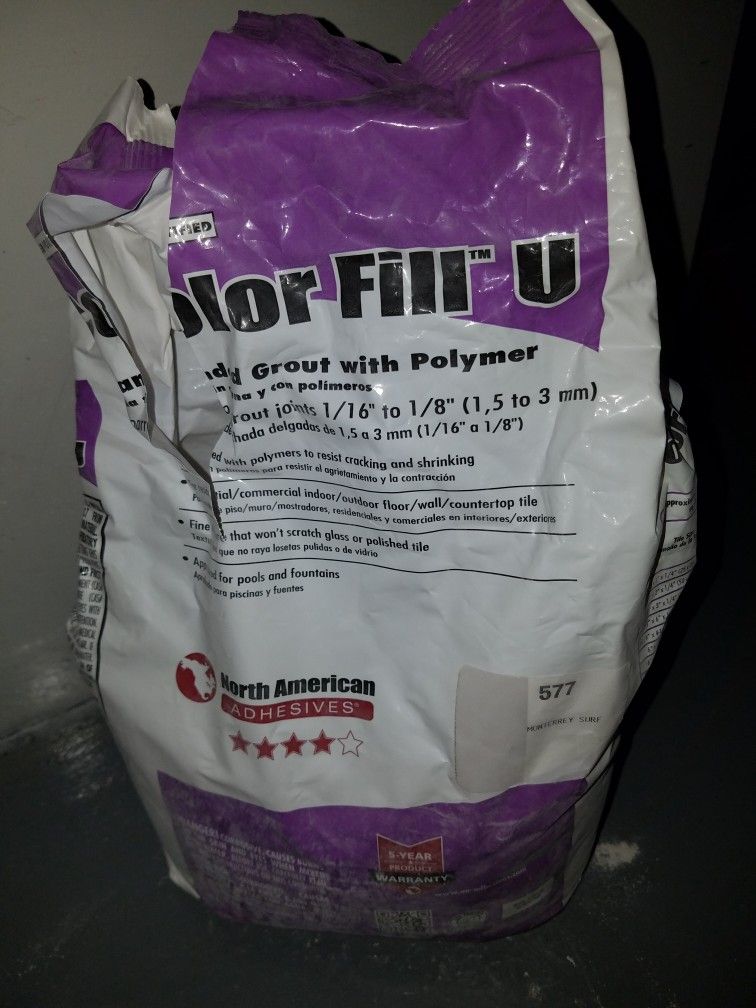 TILE GROUT, UNSANDED. COLOR OFF WHITE, BAG 1/3 FULL