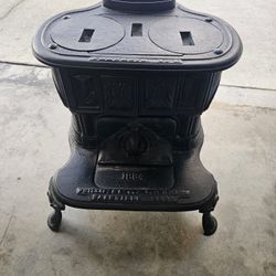 antique cast iron wood or coal parlor stove,