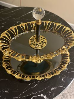 Gold colored, two-tier serving tray with mirrored surfaces,
